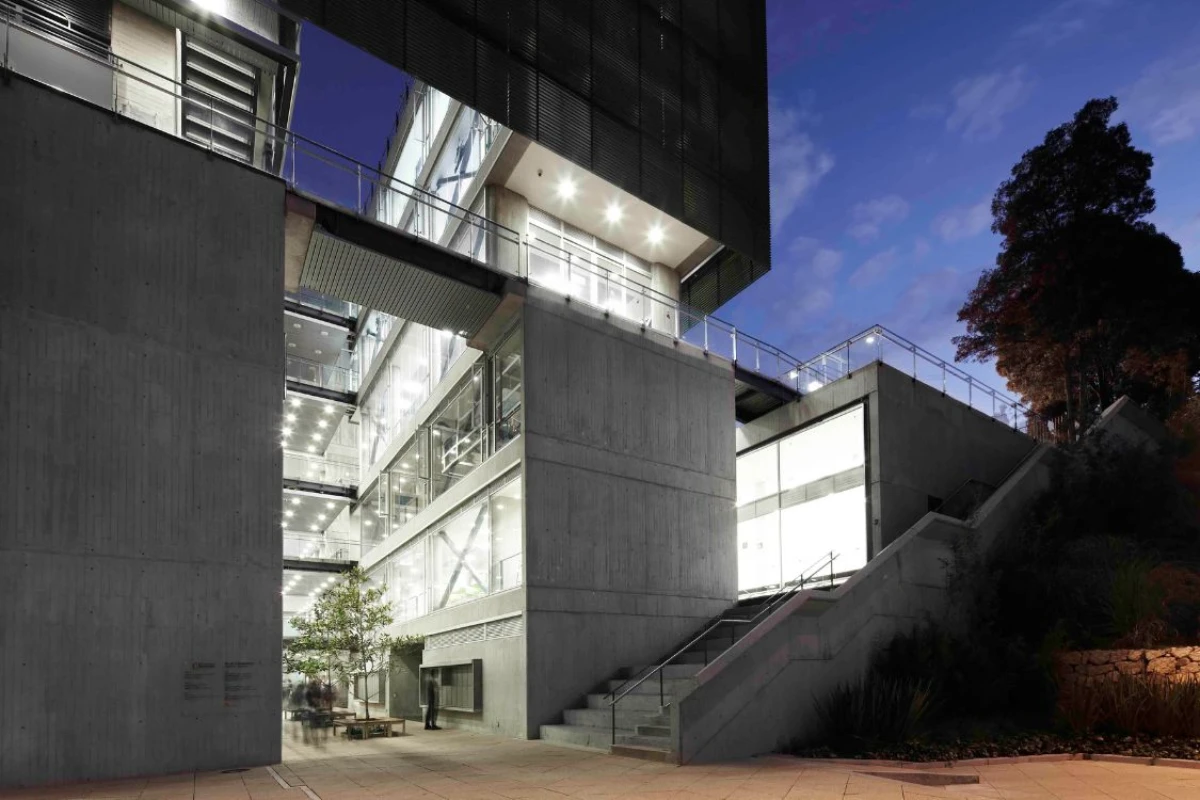 Los Andes University Sports Center - Illuminated concrete and glass exterior highlighting architectural form at night - Felipe Gonzalez Pacheco(0).webp